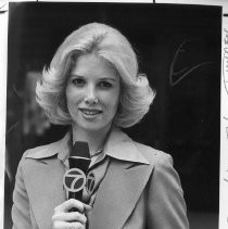 Joan Lunden, holding a microphone, upper body; photo used in newspaper story