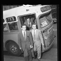 Passengers emerge from a bus