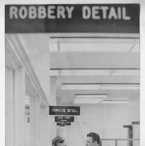 Duane Lowe speak with a male employee outside the Homicide Detail office in the sheriff's offices