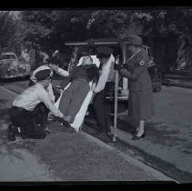 Red Cross loading man on a stretcher