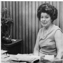 Adelaide Grubbe, receptionist, wears a sleeveless dress