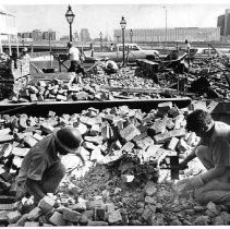 Workers salvage bricks at site of old Democratic State Journal building