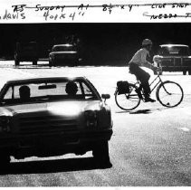 A bicyclist shares the road with cars in Davis