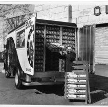 Exterior view of the Old Home Bakers company makers of Old Home and Betsy Ross Bread with one of their delivery trucks parked in front