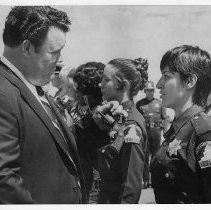 Duane Lowe inspects the revolver of a new deputy sheriff