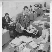 Duane Lowe speaking with an employee in the sheriff's offices