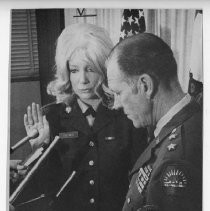 Ruth Holmes, being sworn in--likely as the first woman member of the California National Guard