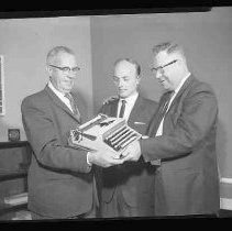 Group of people with typewriter from Insurance Company of North America
