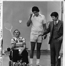 Robert T. (Bob) Matsui visits a children's program, watching with Fred Furukawa as Billy Wright (in a wheelchair) plays badminton