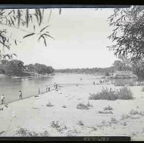 Men fishing from a river bank