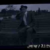 A young man sitting on a park bench