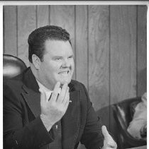 Duane Lowe, seated at his desk and gesturing