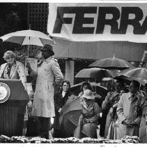 Geraldine Ferraro campaigning in San Francisco. Willy Brown shown holding umbrella, on extreme left is John Garamendi