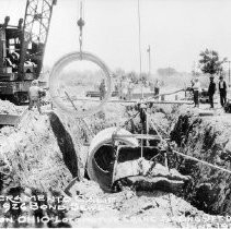 "Twenty-five Ton Ohio Locomotive Crane Placing 9' Diam. Pipe"