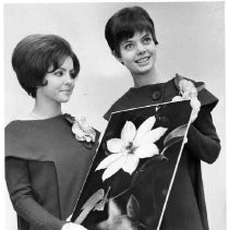 Two 1967 Camellia Festival Princesses, Faye Bermudez, left and Barbara Rasmussen admire the one of the photographs from the photo competition