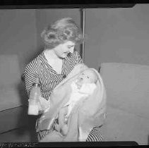 A young woman holding a baby