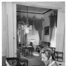 Woman sitting at piano inside Stanford Home