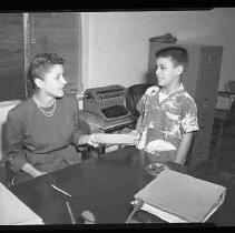 A woman and boy in an office