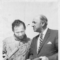 Dr. Alvin Marks, pilot and owner of Skymark Airlines. Here, after the flight, standing beside an unidentified man