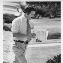 Phillip Isenberg, Sacramento City Councilman, Mayor, Assemblymember. He is shown as candidate for mayor, walking while reading paperwork