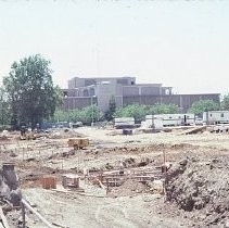 Site of the Downtown Plaza Parking Garage, Lot "G" near Macy's Department Store, 4th, 5th K and L Streets under construction. This view is looking east from the Fratt Building in Old Sacramento