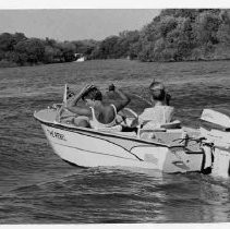 Two unidentified women enjoy boating on the water