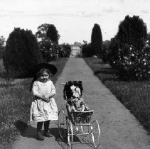 "Annie and her Doll in Carriage"