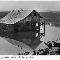 Barn Reflects in Receding Flood Water