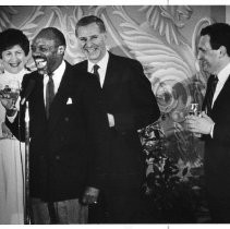 Assembly Speaker Willie Brown offers toast to Governor George Deukmejian while the governor's wife (Gloria) watches. On the far right is David Roberti