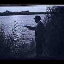 A young man pointing a pistol