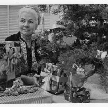 Dr. Irene Hickman, the Sacramento County assessor, stands behind some of the many gifts received in the assessor's office (beneath a small Christmas tree)