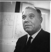 Ralph L. Herod, Executive Director of the Redevelopment Agency of the City of Sacramento, in front of a schematic of the area north of Capitol Mall