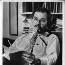 Phillip Isenberg, Sacramento City Councilman, Mayor, Assemblymember. He is shown in his office, on the phone