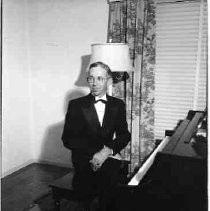 Unidentified man sitting at a grand piano