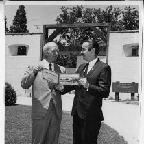 View of Frank Christy, on the right and John H. Sievers on the left, the secretary-treasurer of Fort Sutter Savings & Loan Association, sponsor of the booklet they are holding telling the "Story of Fort Sutter."