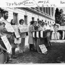 Demonstrators with signs protest the military draft in front of the U.S. Post Office in downtown Sacramento