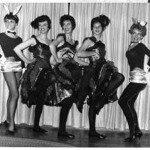 Three unidentified women dance the "Can-Can"