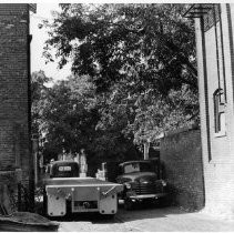 Two trucks in an alley
