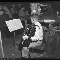 Boy playing an accordian