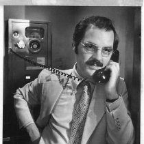 Phillip Isenberg, Sacramento City Councilman, Mayor, Assemblymember. He is shown standing and talking on a phone