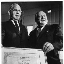 Harry Finks, left Director of Public Relations for the California Labor Federation receives an award from Claude L. Kemp for his sevice to veterans