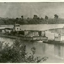 View of the river barge, "Nebraska" loaded with airplane parts enroute for overhaul at the Sacramento Air Depot