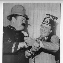 Duane Lowe, in Keystone Cops mustache and garb, being initiated into Ben Ali Shrine