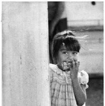 A shy girl at a farm labor camp