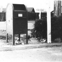 Post Office Mail Box with trash scattered about