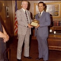 Sacramento Police Chief John Kearns presents award plaque to Ernest Luzania, Special Agent, US Secret Service