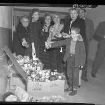 Unidentified group of people donating to a food drive