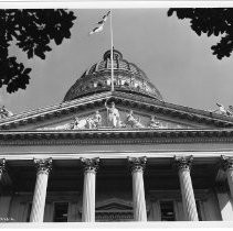 Exterior view of the western entrance of the California State Capitol building showing the statuary above the portico