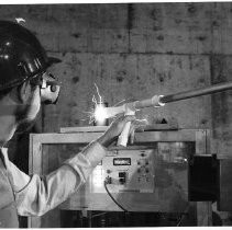 Dr. John Asmus aims the laser beam used to reveal the original dome design on the walls of the California State Capitol building