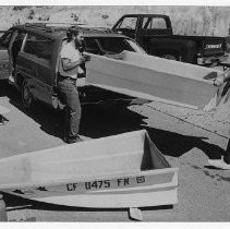 Bob Grind (left) taking part of a boat from a station wagon